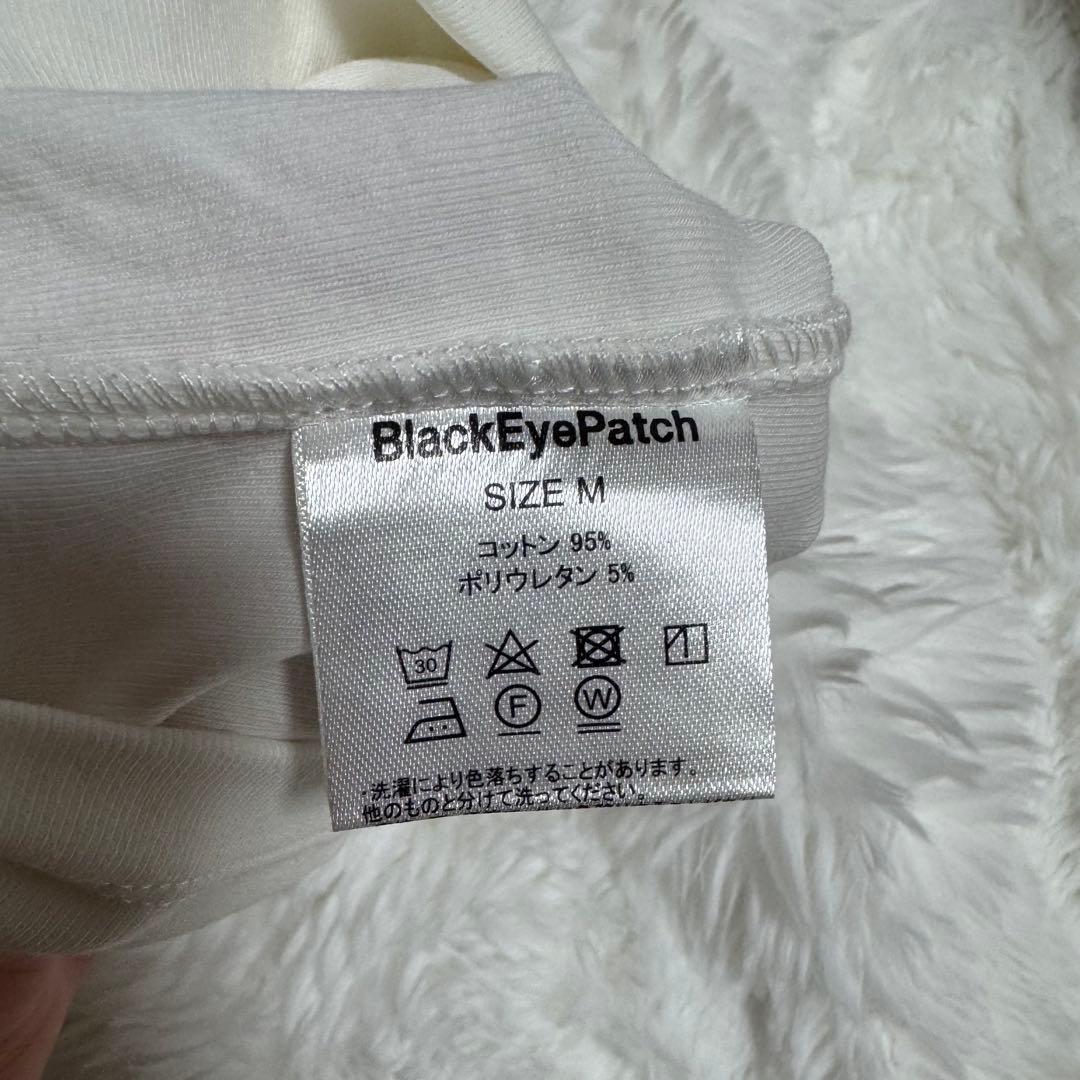 トップス Black eye patch SPLAYED SCRIPT BABY TEE