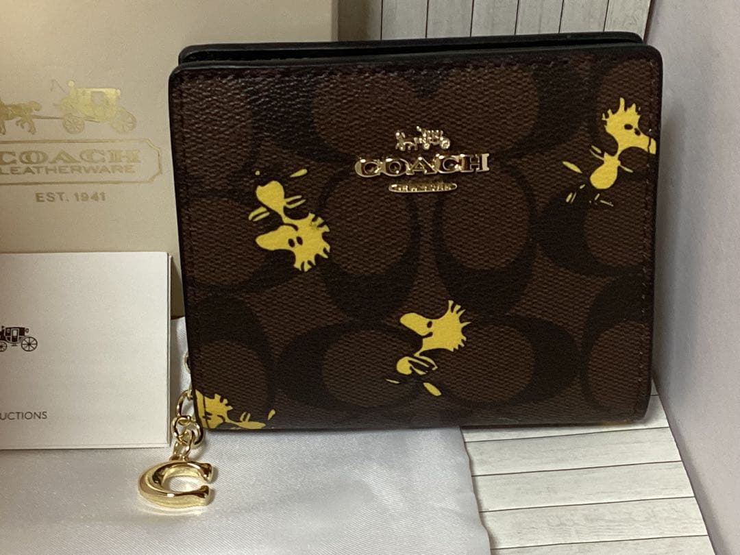 新品保存袋付きコーチスヌーピーCOACH 二つ折り財布ケース本物ラウンド