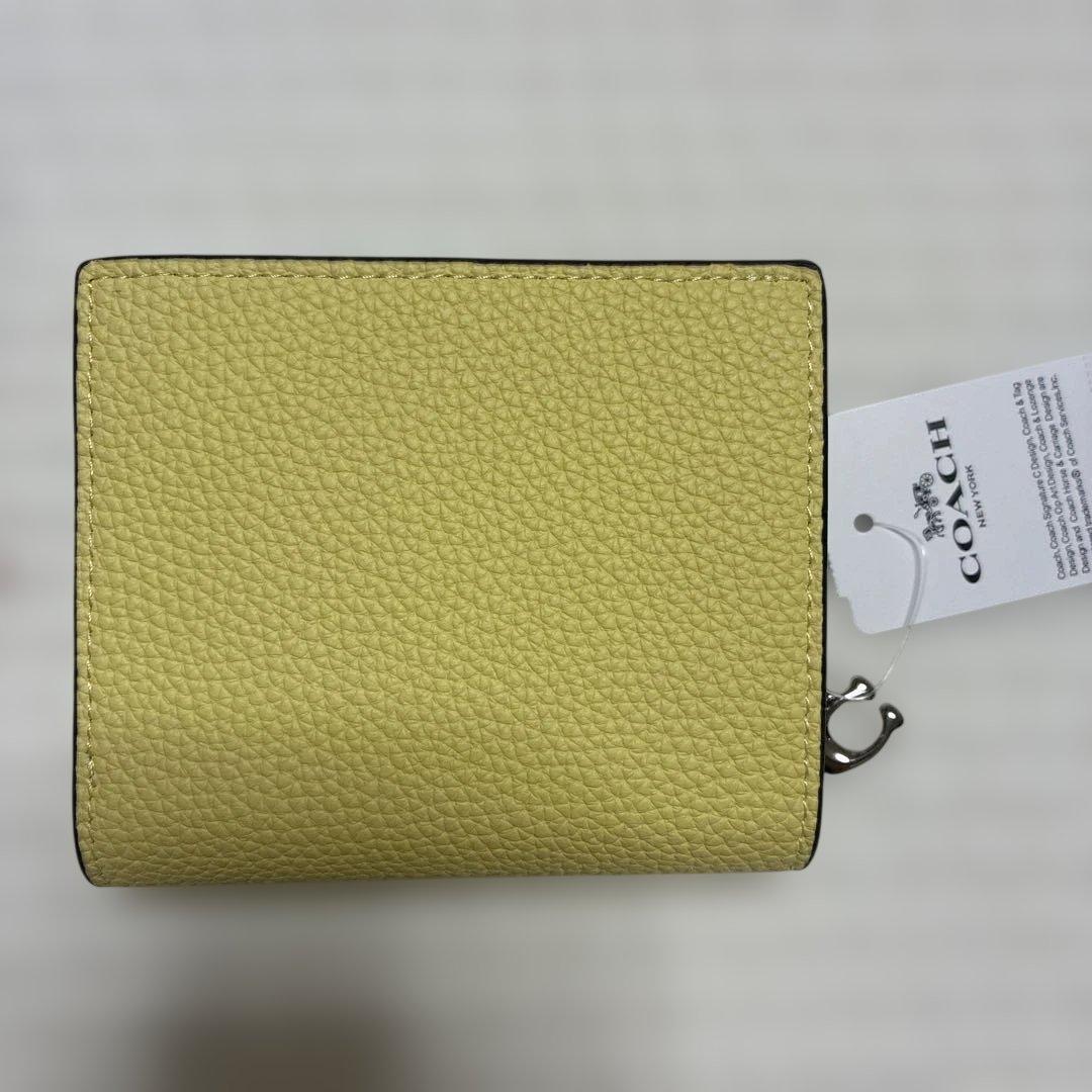 【新品未開封】COACH コーチ 二つ折り財布　黄色　チャーリーブラウン