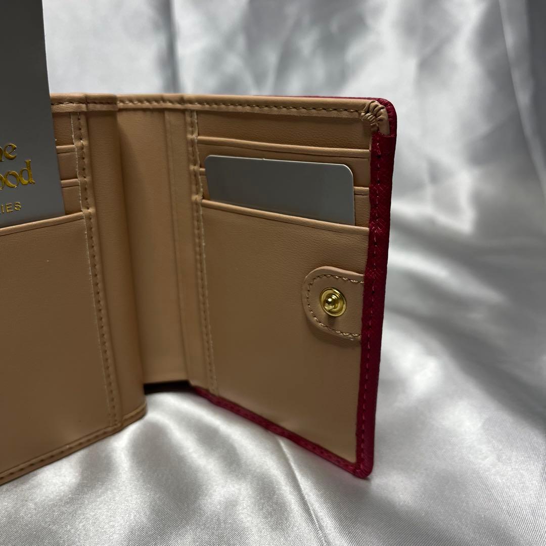 新品Vivienne Westwoodピーチ 蝶々留め 二つ折り財布 可愛い