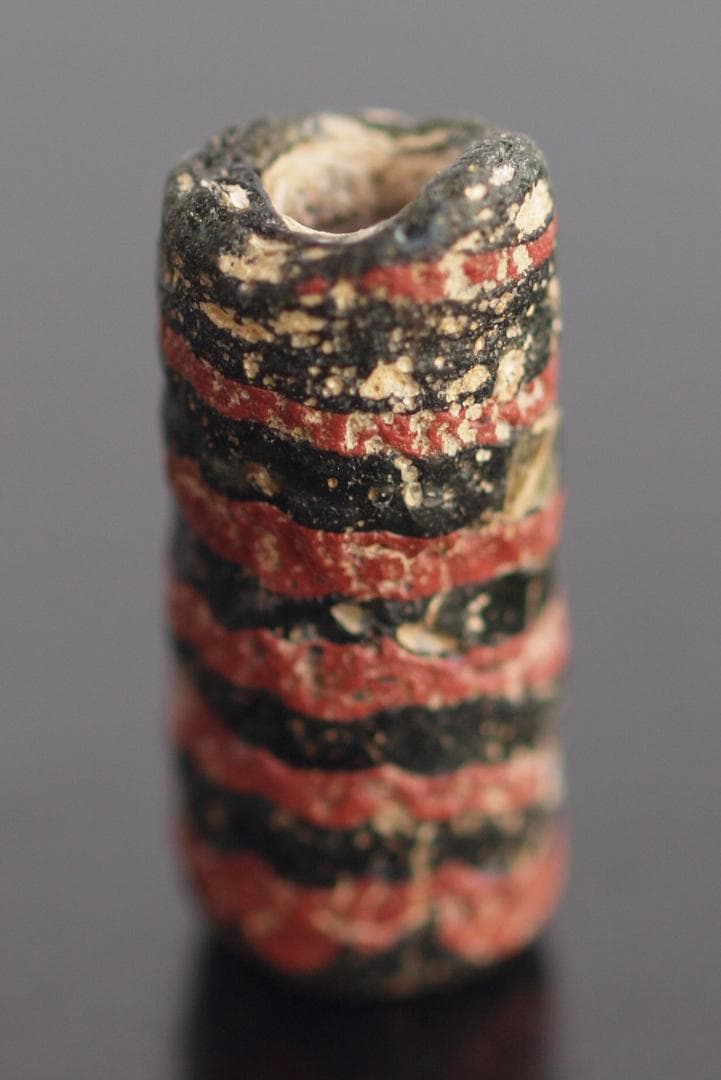 大型の漆黒管玉に、赤茶の螺旋紋と細く浅い引っ掻き紋1-4Cローマン・ビーズ銀化も