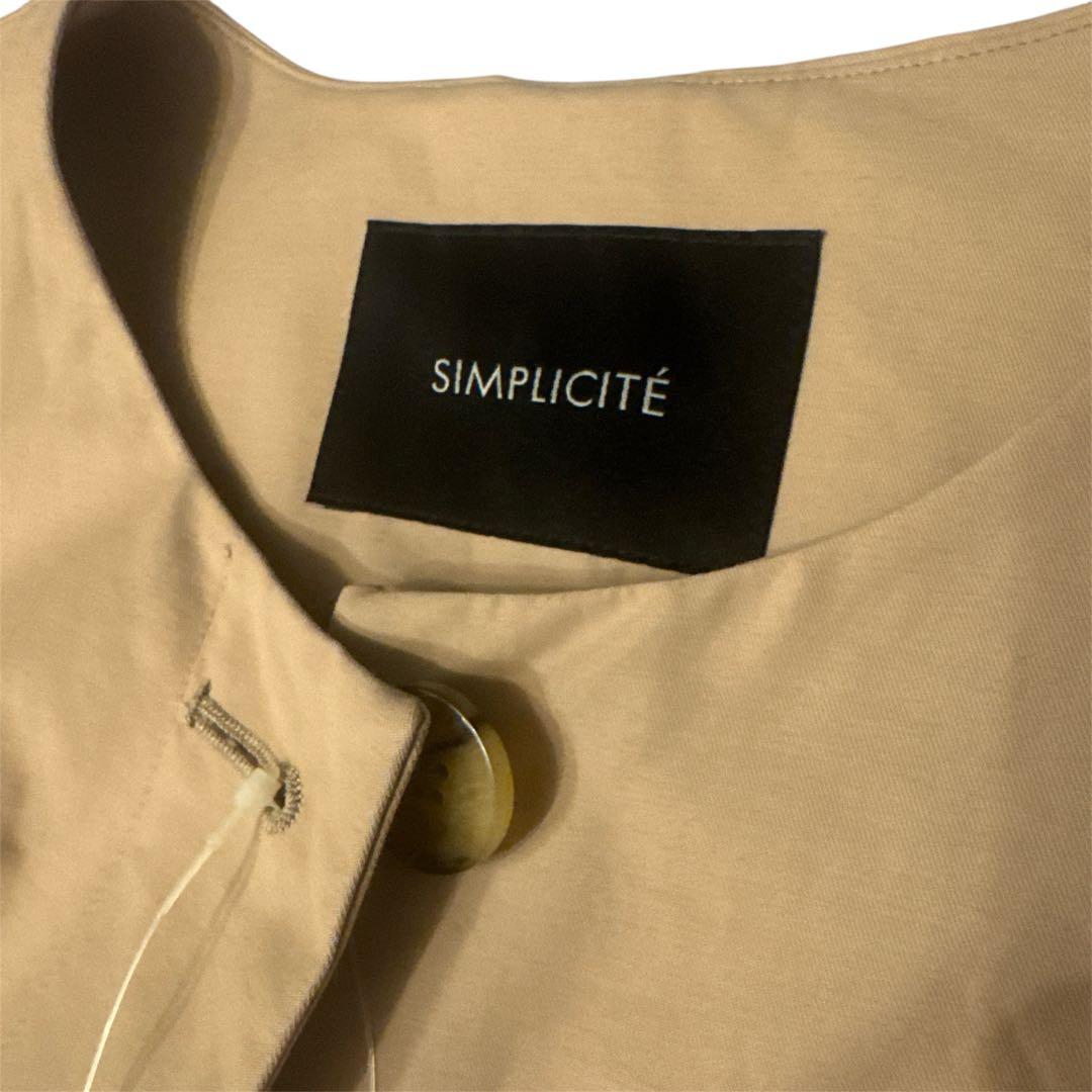 タグ付きシンプリシテェSIMPLICITEスプリングコートノーカラーロングコート