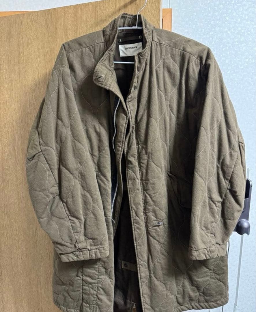 ジャケット・アウター ANACHRONORM QUILTING FISH TAIL COAT
